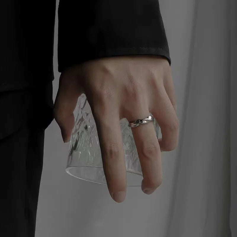 A small, niche, high-end Instagram-worthy ring in a minimalist, cool-toned, high-fashion style for both men and women.